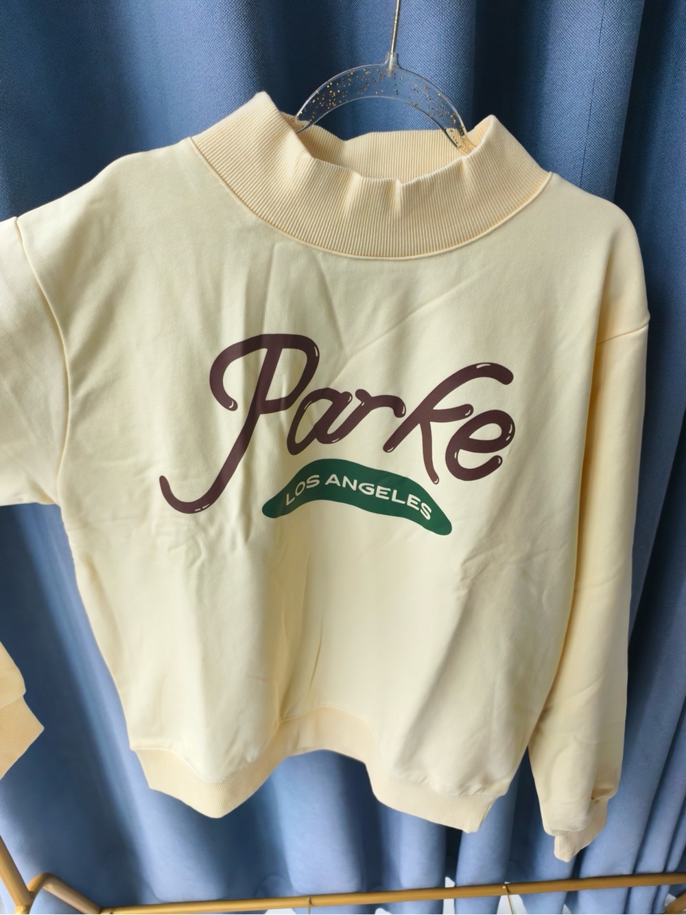 Parke Cream Mock Neck Sweatshirt with Brown Logo and Green Accent